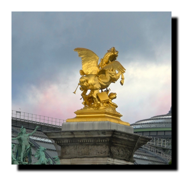 Une des statues du Pont Alexandre III, derrière le haut du Grand Palais et un ptit peu de bleu et du rouge des avions du 14 juillet.